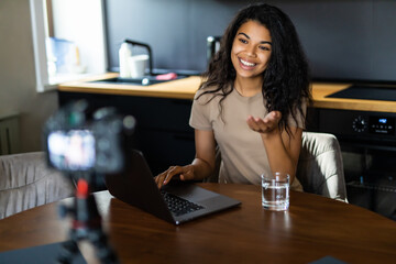 African American blogger recording video about sport and healthy food at home