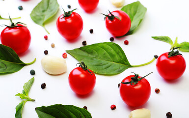Tomato, basil, spices, pepper, garlic. Vegan diet food, creative cherry tomato composition isolated on white.