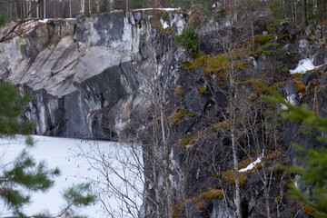 Fototapeta na wymiar Ruskeala Mountain Park - Landmark of Russia. Marble mountain rock quarry winter landscape, Karelia