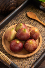 Fresh fruit figs on the background of retro Chinese style tea tray