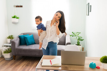 Mother working at home with a baby