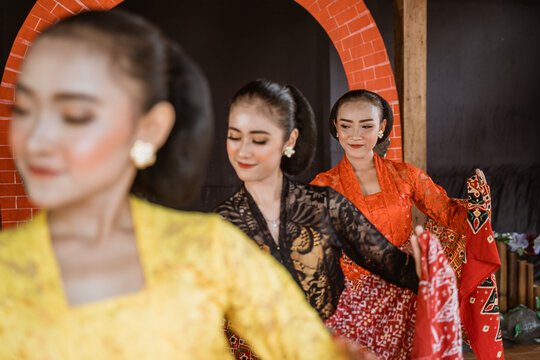 portrait of three young women presenting traditional Javanese dance movements