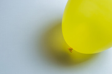 Yellow balloon with shadow lying on gray background. Minimalistic banner with colors of the year 2021 - Illuminating and Ultimate Gray. - 398375515