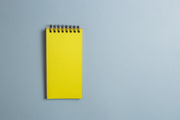 Yellow notepad with blank page for text on gray background. Minimalistic banner with colors of the year 2021 - Illuminating and Ultimate Gray. - 398375584