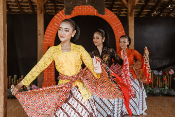 portrait of three young women presenting traditional Javanese dance movements