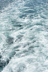 Blue frothy surface of seawater. Background. Pattern. Background texture of blue and turquoise water and waves of the Bosphorus and Marmara Sea.