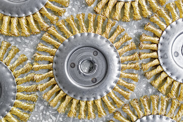 Disk brush. Round brush with metal pile or bristles for processing materials. Solid background close-up