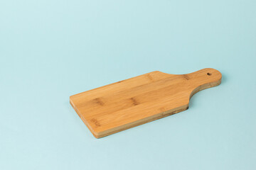 Classic wooden cutting Board on a blue background.