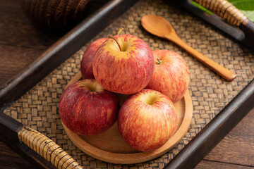 Fresh fruits and small apples on the background of retro Chinese style tea tray