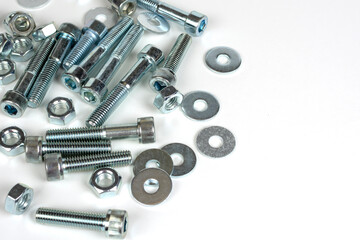 on a white background galvanized metal fasteners close up