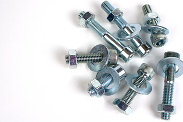 on a white background galvanized metal fasteners close up