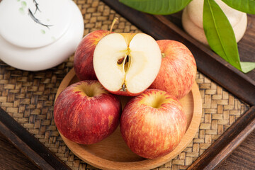 Fresh fruits and small apples on the background of retro Chinese style tea tray