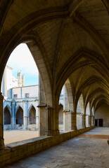 Arched corridor in courtyard of Cathedral of Saint Nazaire, Beziers, France