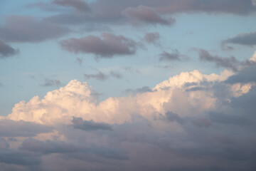 Beautiful sky background. Light blue sky with dramatic orang, pink, and gray clouds. Perfect for sky replacement. High quality photo