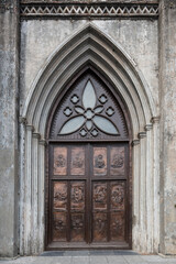 Fototapeta na wymiar Brass door with bas reliefs captured at St Joseph's cathedral in the old quarter of Hanoi, Vietnam