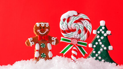 Christmas Lollipop, Christmas tree, ginger man in the snow on a red background. Copy space. Christmas background.