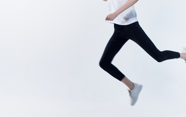 energetic sportswoman running on a light background in sneakers cropped view Copy Space