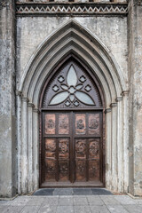 Brass door with bas reliefs captured at St Joseph's cathedral in the old quarter of Hanoi, Vietnam