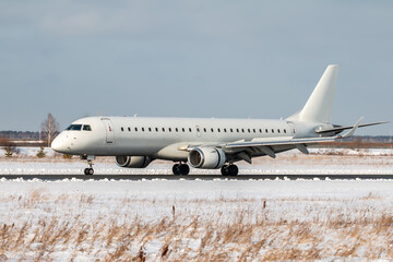 White passenger airliner on the runway of a winter airport