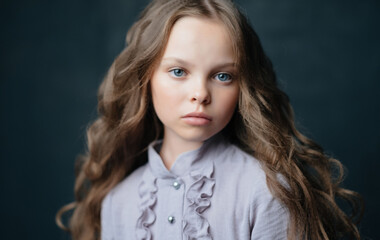 Naklejka premium Beautiful little girl in luxury dress hairstyle Studio