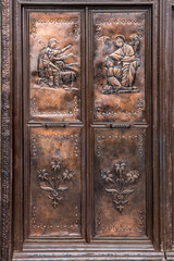 Brass door with bas reliefs captured at St Joseph's cathedral in the old quarter of Hanoi, Vietnam