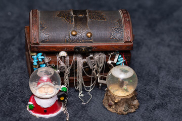 Shot of cute decorative toys in glass balls guarding a jewelry box full of jewels