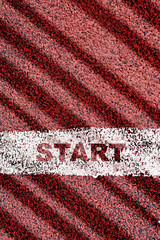 Top view of start word on starting line and white sneaker on red sport track. Business success concept and challenge idea