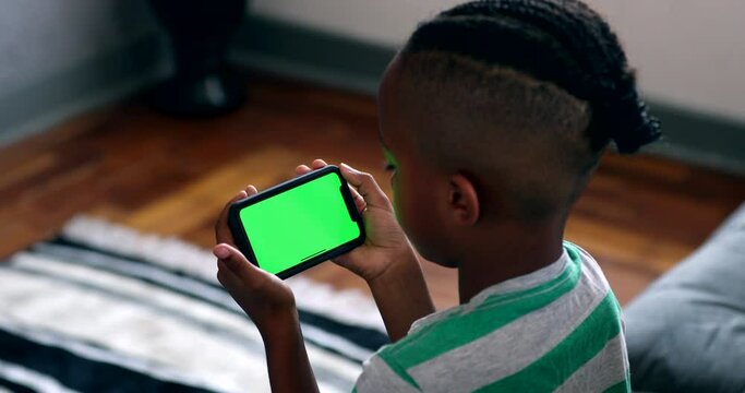 African child holding cellphone with mock-up green screen