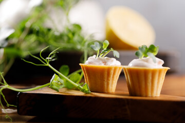 Canapes with light cream filling. Still life with microgreens. The concept of an appetizing snack.