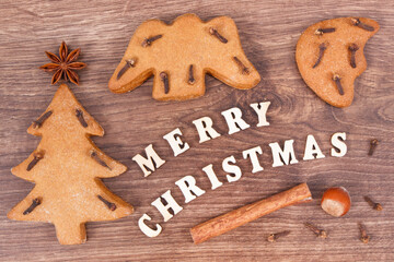 Inscription Merry Christmas with homemade gingerbreads and cookies for festive time