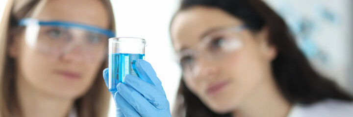 Two scientists are conducting experiments in laboratory