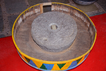Old or Vintage flour mill stone displayed at shop in India