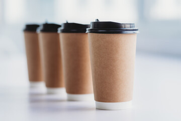 Four cups of coffee are placed in a row on the table