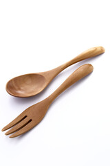 Close up wooden fork and spoon on white