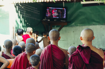 a group of people watching a television