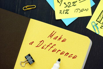 Business concept meaning Make a Difference with inscription on the piece of paper.