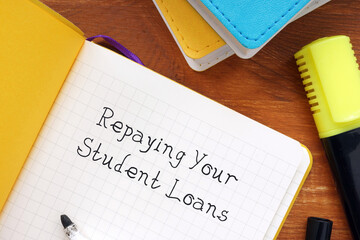 Business concept meaning Repaying Your Student Loans with sign on the page.