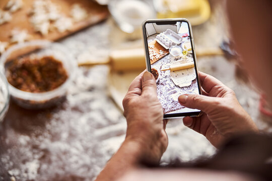 Cook taking a photo of kitchen workplace on smartphone