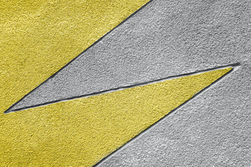 Yellow and gray stone wall with geometric pattern, background, texture. Trendy colors 2021