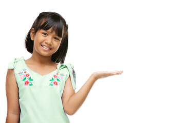 Asian cute girl presenting something on hand over white background