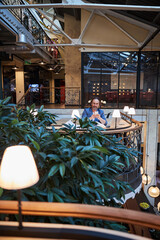 Focused gentleman checking his smartphone in comfortable lounge