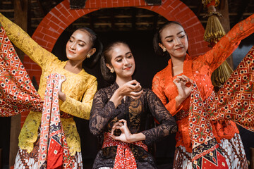 portrait of a young woman wearing Javanese kebaya traditional clothes with dancing pose