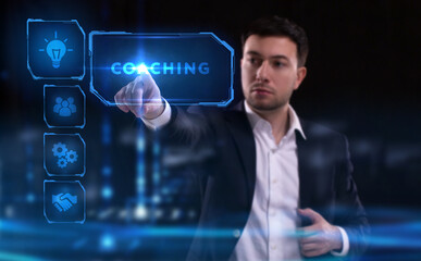 Business, Technology, Internet and network concept. Young businessman working on a virtual screen of the future and sees the inscription: Coaching