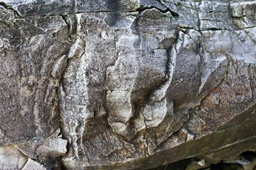 mountain textures of stones with interlayers of gypsum, colored quartz, clay, sand and other layers of various ores, with different textures, color and density, in gypsum ore quarry.