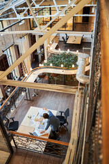 Busy man alone at an empty co-working space