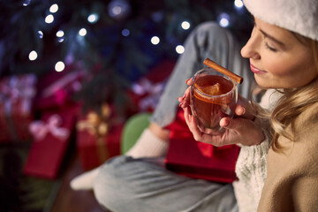 Magnificent blonde lady enjoying great evening in room indoors inn Christmas eve