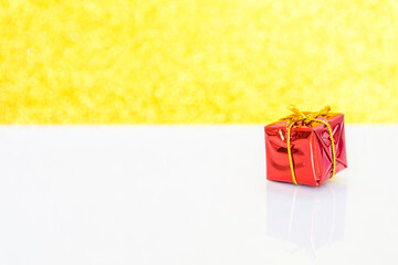 Red gift box with space on blurred glitter gold background, Christmas concept background, New year gift