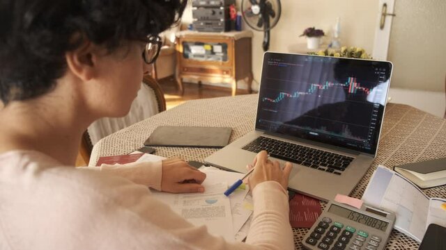 Home office working environment. Using laptop and working efficiently. Using technology and working at home productively. Young female adult study focused.