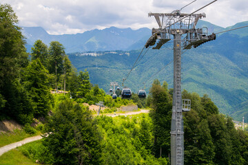 Fototapeta premium Cable car or cable railway in summer mountains