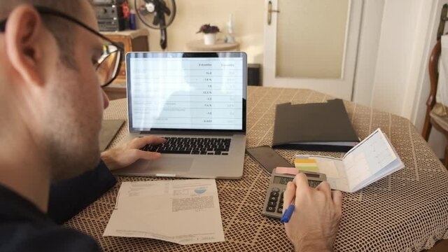 Home office working environment. Using laptop and working efficiently. Using technology and working at home productively. Young male adult study focused.